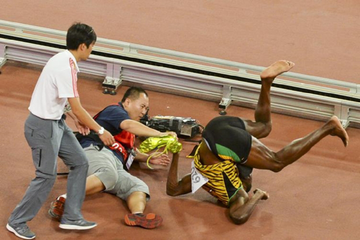 Bolt wins easily, then loses to cameraman